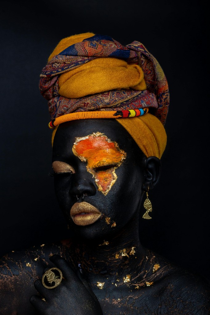 Portrait of a person in warm-toned headscarf artwork representing diaspora identity